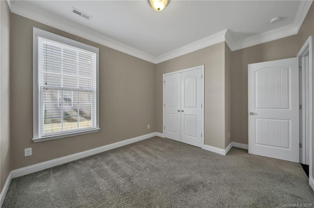 264 Annatto Way Tega Cay, SC 29708 - Photo 20 of 36 a view of an empty room with a window and a bathroom