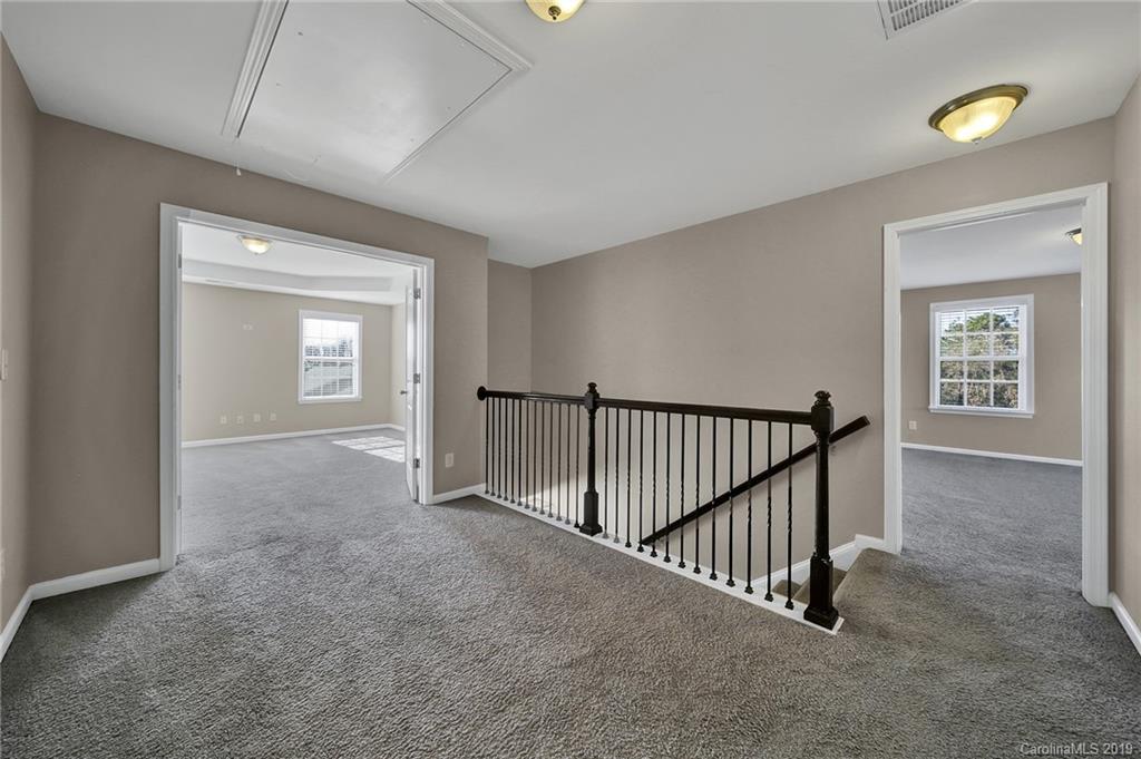 264 Annatto Way Tega Cay, SC 29708 - Photo 21 of 36 a view of a hallway with windows