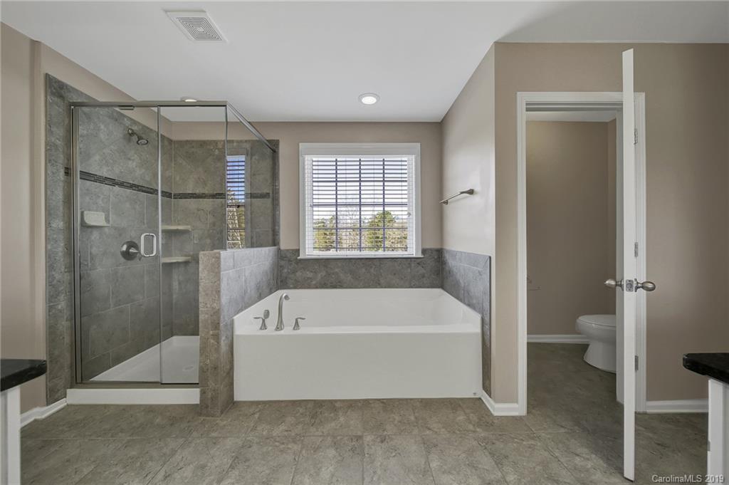 264 Annatto Way Tega Cay, SC 29708 - Photo 26 of 36 a bathroom with a tub and a shower