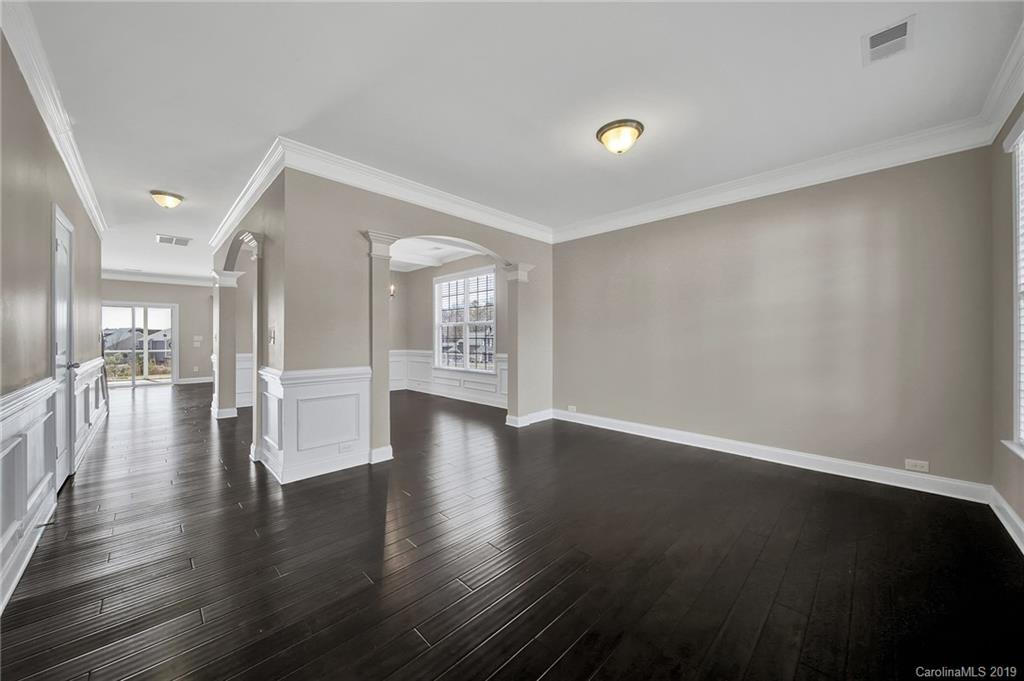264 Annatto Way Tega Cay, SC 29708 - Photo 4 of 36 a view of an empty room with wooden floor and a window