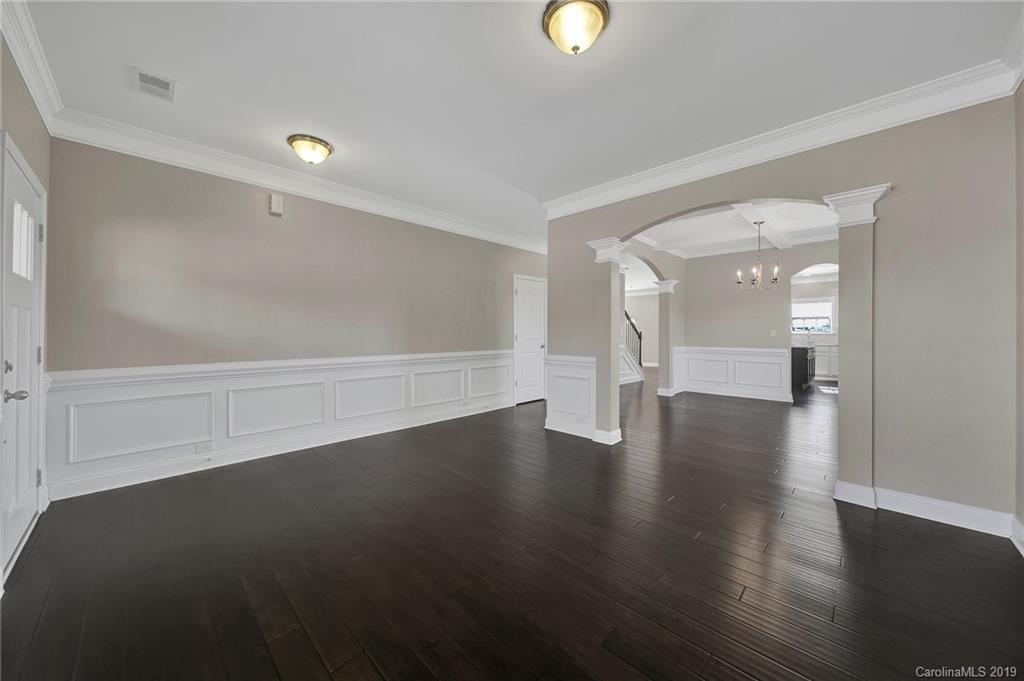 264 Annatto Way Tega Cay, SC 29708 - Photo 6 of 36 an empty room with wooden floor and windows