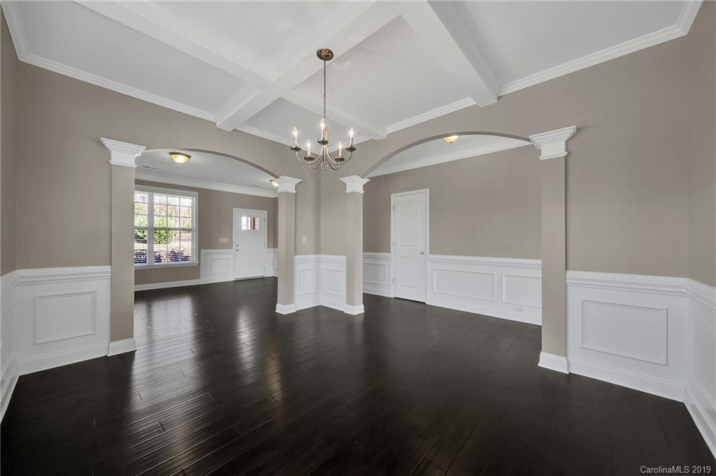 264 Annatto Way Tega Cay, SC 29708 - Photo 7 of 36 a view of a big room with wooden floor chandelier and windows
