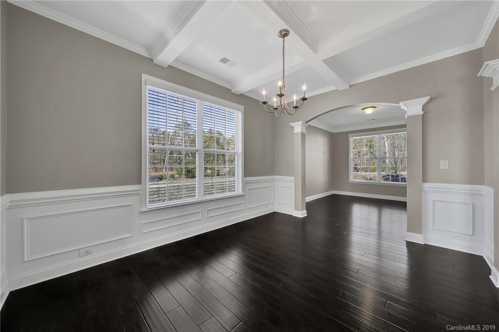 264 Annatto Way Tega Cay, SC 29708 - Photo 9 of 36 a view of an empty room with wooden floor and a window
