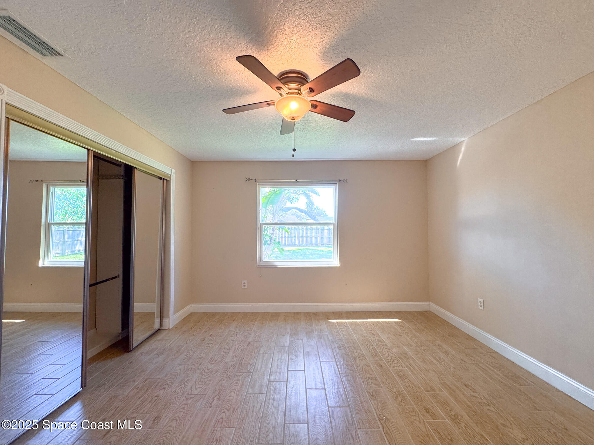 871 Southern Pine Trail Rockledge, FL 32955 - Photo 13 of 36 an empty room with windows and fan