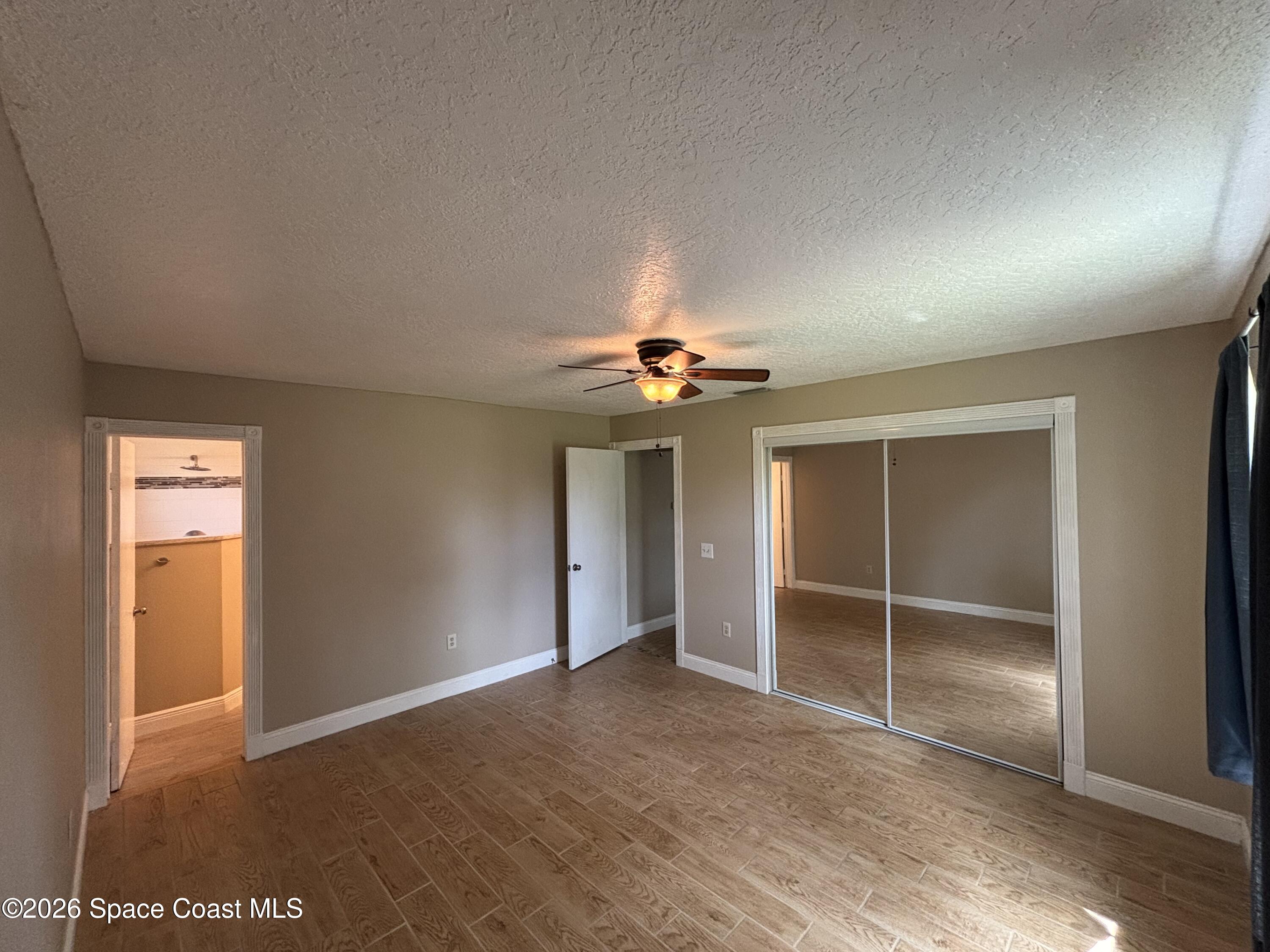 871 Southern Pine Trail Rockledge, FL 32955 - Photo 14 of 36 an empty room with closet and chandelier fan