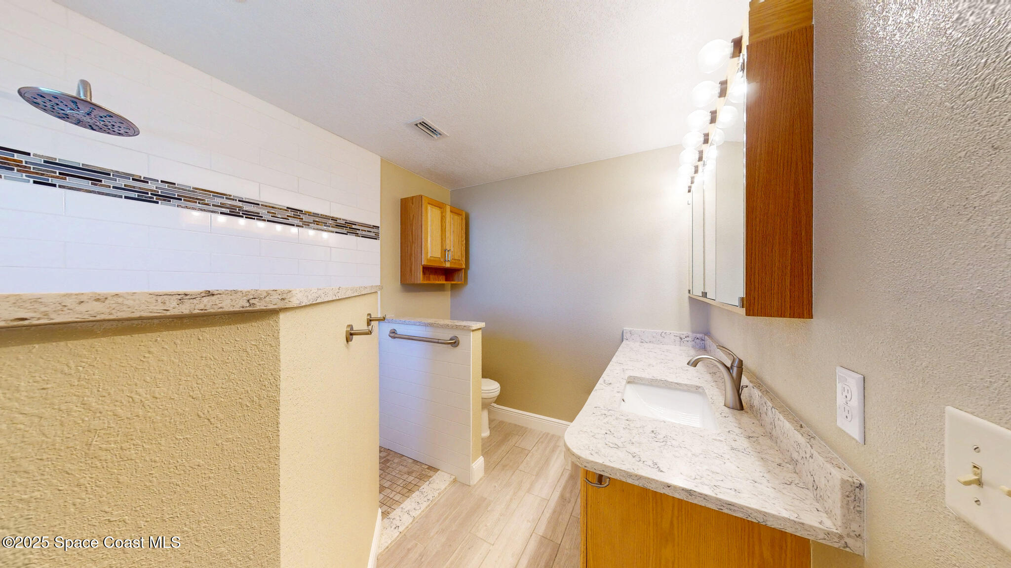 871 Southern Pine Trail Rockledge, FL 32955 - Photo 16 of 36 a bathroom with a granite countertop sink and a mirror