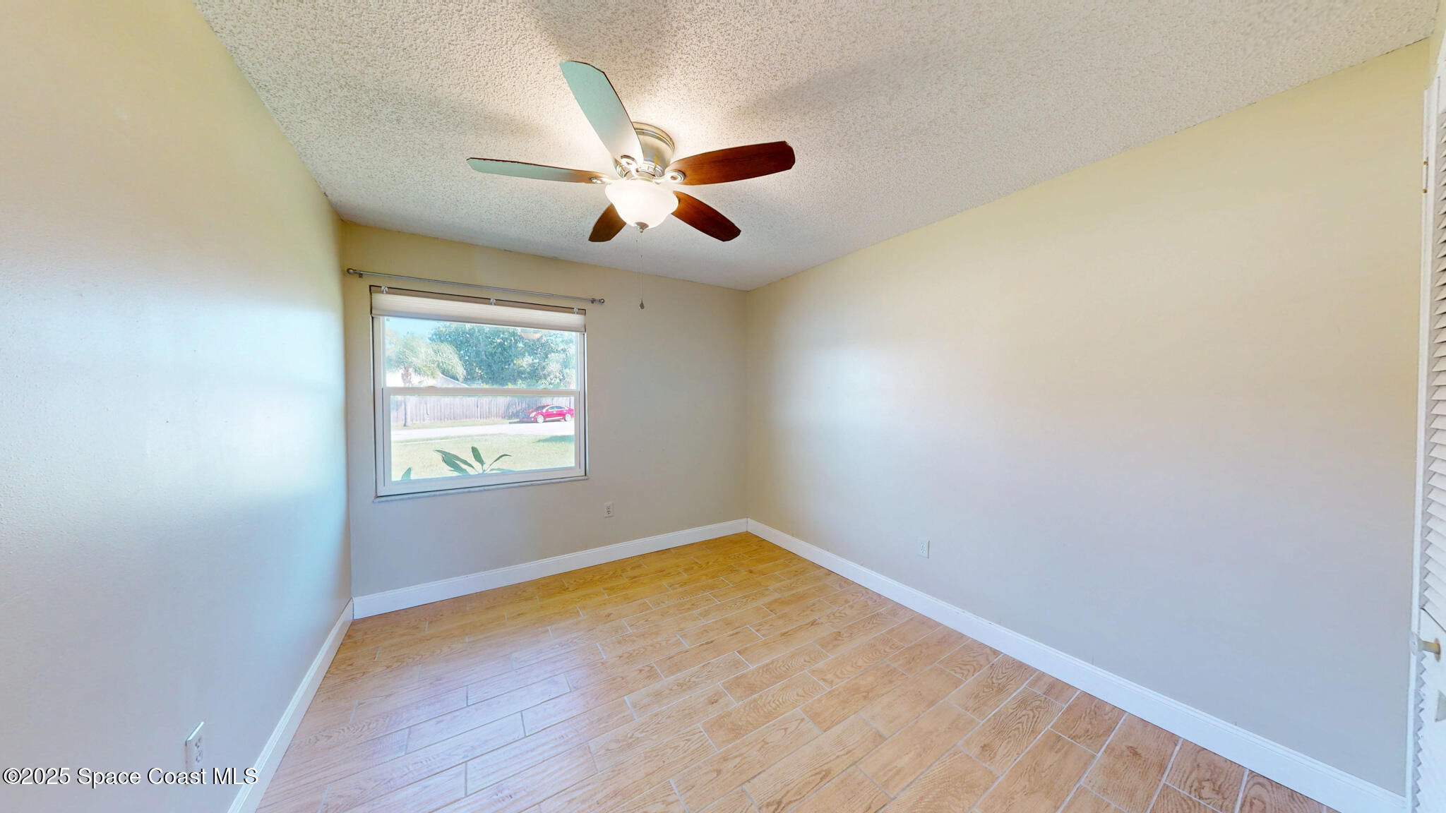 871 Southern Pine Trail Rockledge, FL 32955 - Photo 22 of 36 an empty room with windows and fan