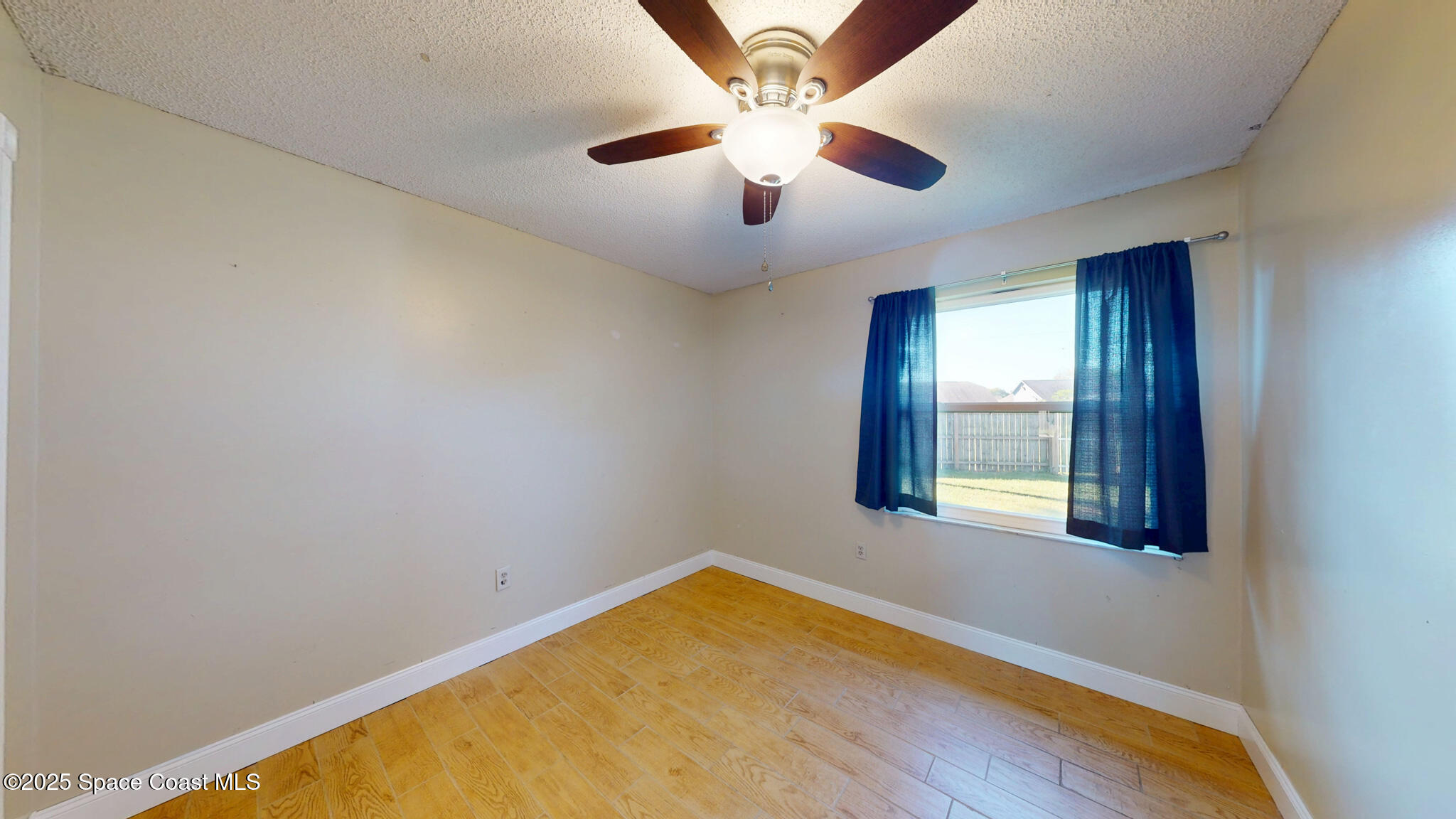 871 Southern Pine Trail Rockledge, FL 32955 - Photo 25 of 36 an empty room with windows and ceiling fan