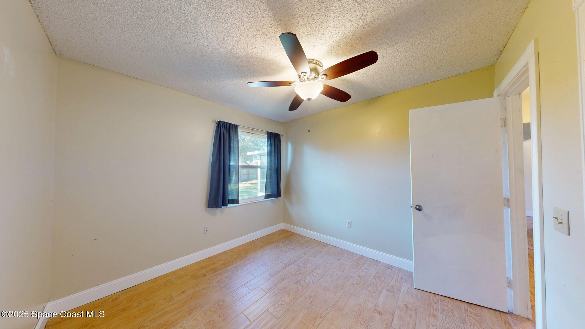 871 Southern Pine Trail Rockledge, FL 32955 - Photo 26 of 36 a view of empty room with wooden floor and fan