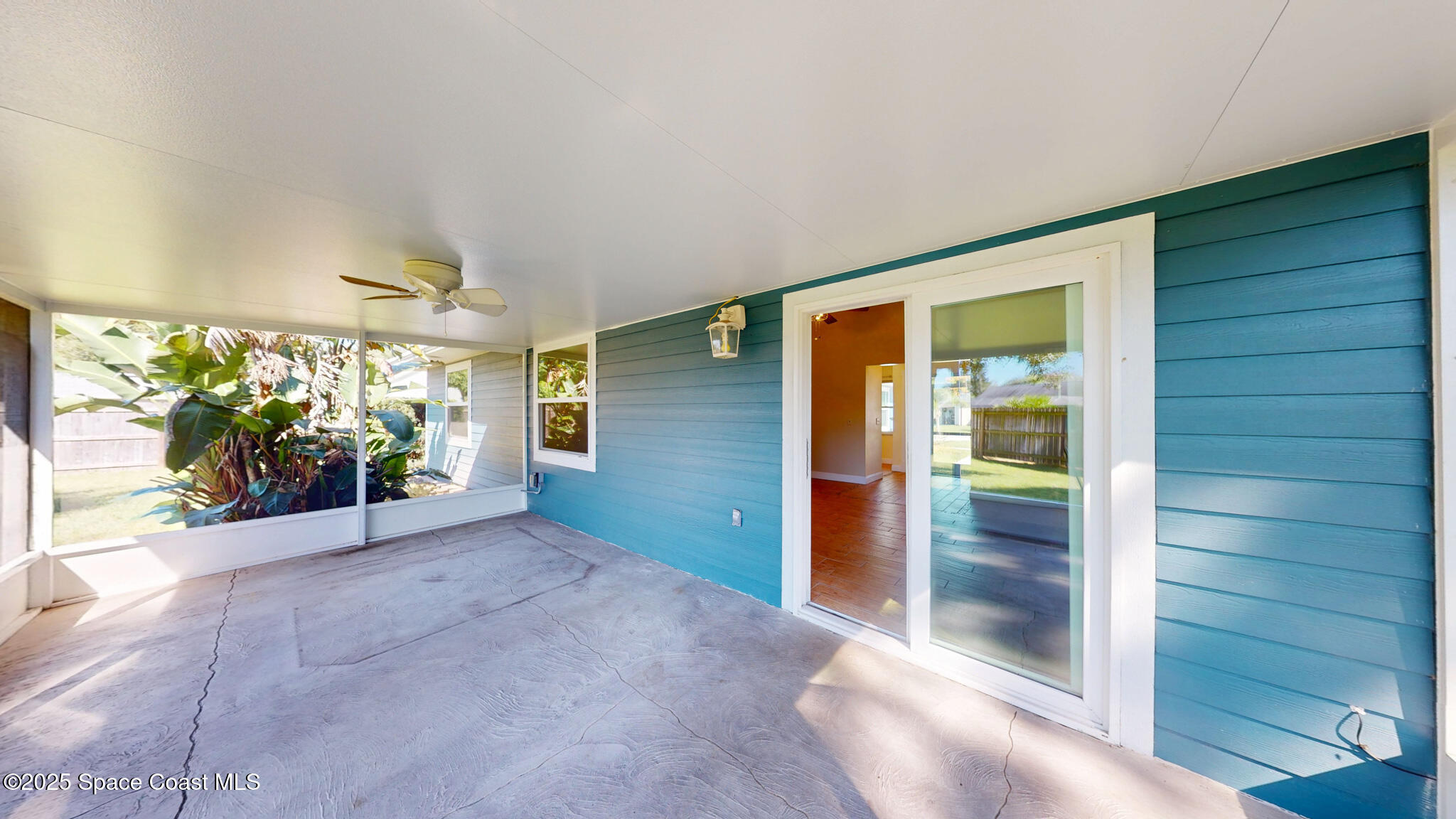 871 Southern Pine Trail Rockledge, FL 32955 - Photo 31 of 37 an empty room with windows and way to kitchen