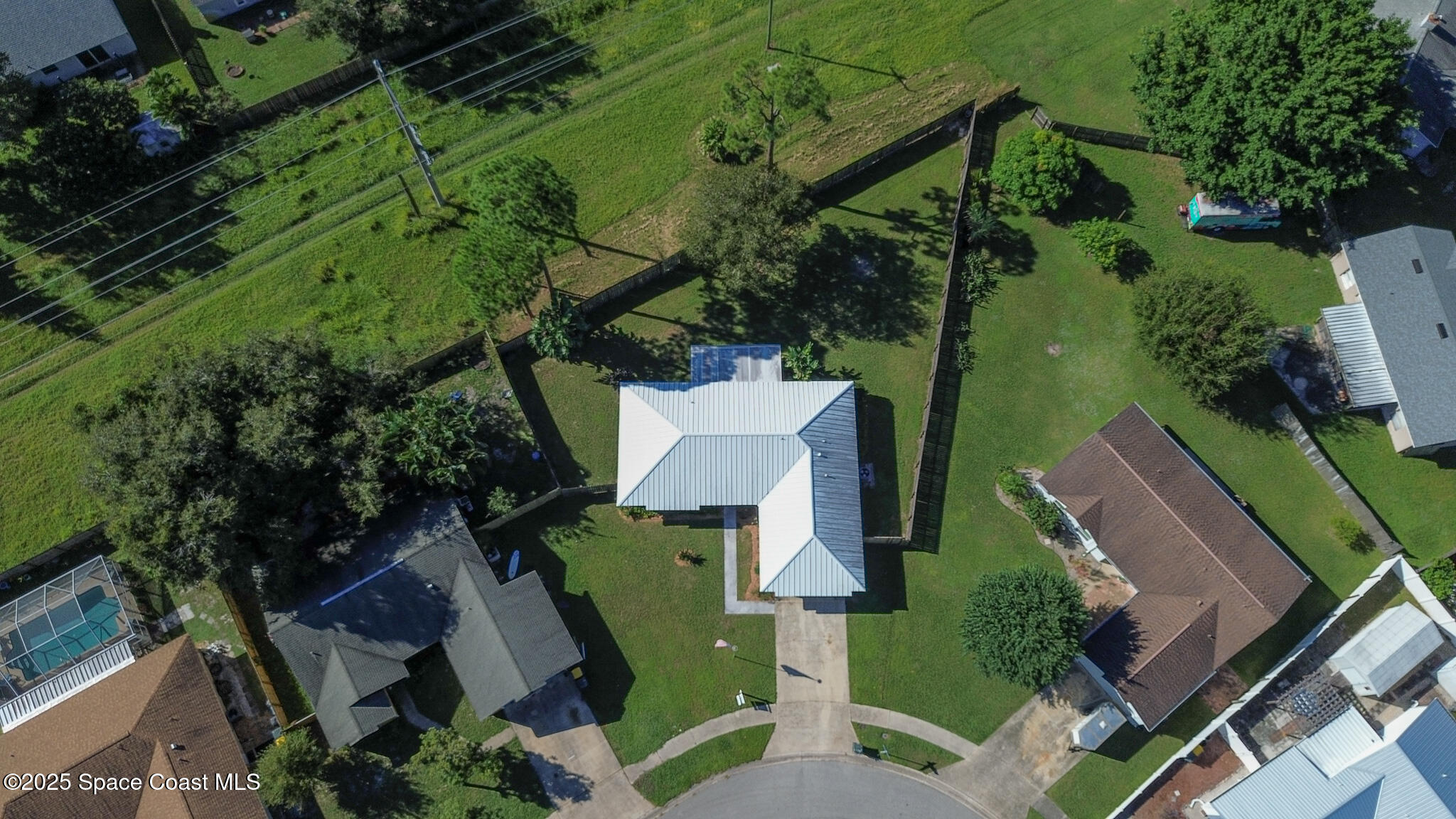 871 Southern Pine Trail Rockledge, FL 32955 - Photo 4 of 36 an aerial view of a house with a yard and lake view