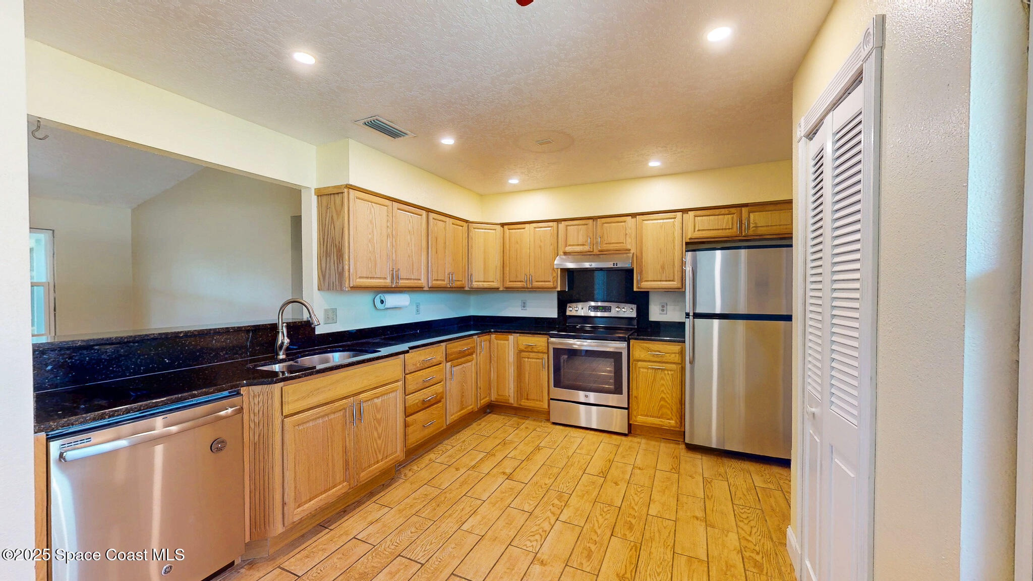 871 Southern Pine Trail Rockledge, FL 32955 - Photo 5 of 36 a kitchen with stainless steel appliances a refrigerator sink and microwave