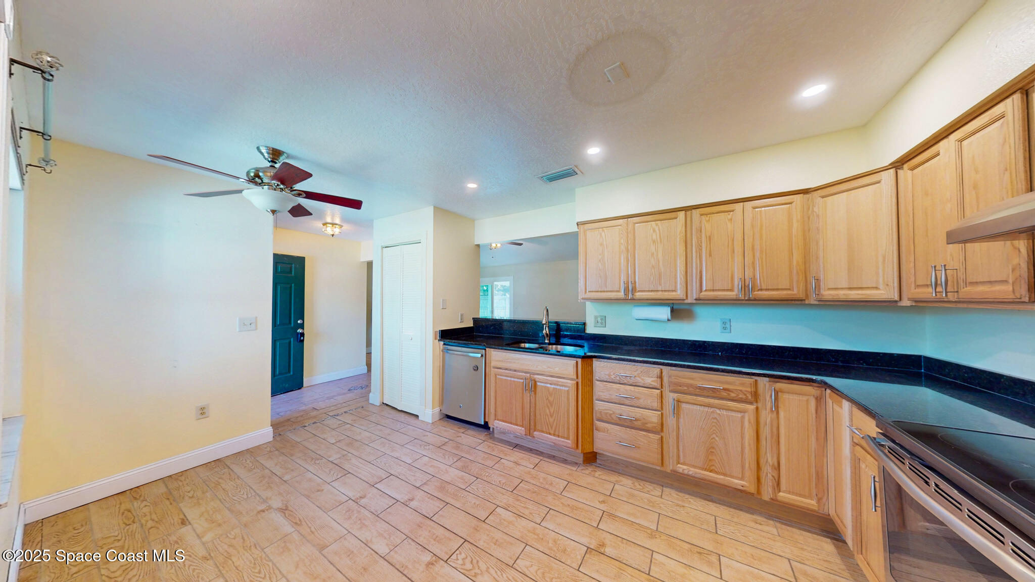 871 Southern Pine Trail Rockledge, FL 32955 - Photo 7 of 36 a kitchen with stainless steel appliances granite countertop a sink and cabinets
