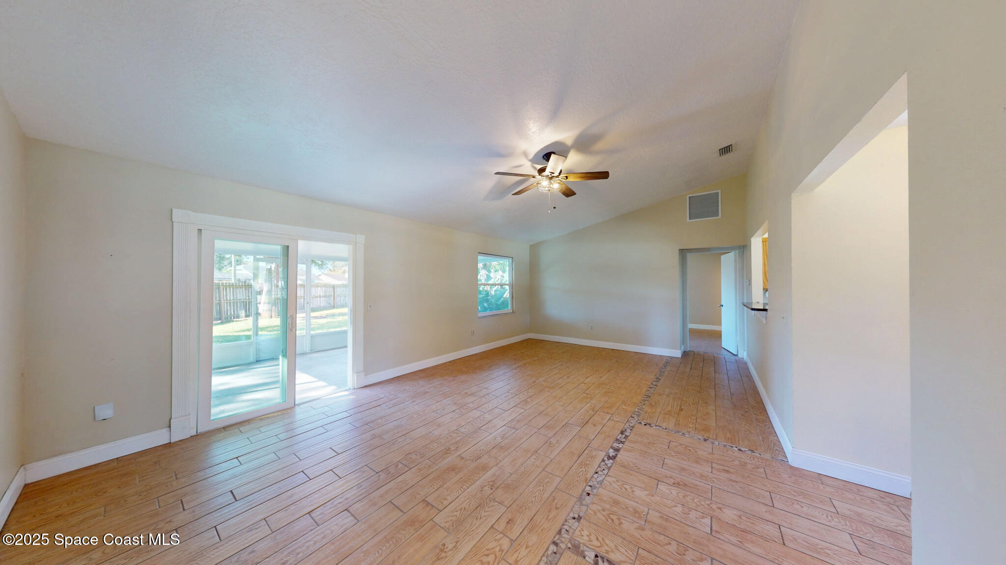 871 Southern Pine Trail Rockledge, FL 32955 - Photo 9 of 36 a view of an empty room with window and wooden floor