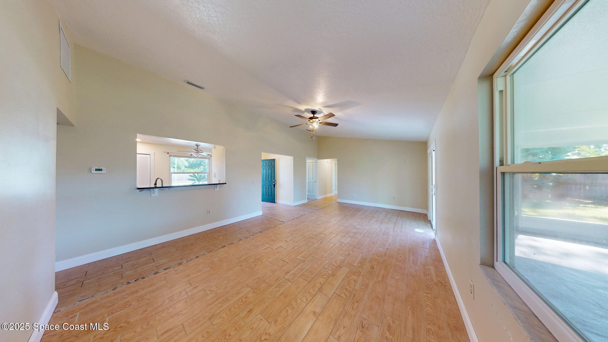 871 Southern Pine Trail Rockledge, FL 32955 - Photo 10 of 36 wooden floor in an empty room with a window