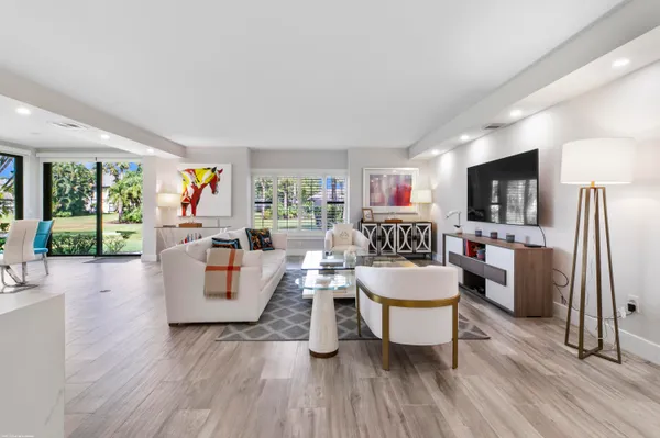 a living room with fireplace furniture and a wooden floor