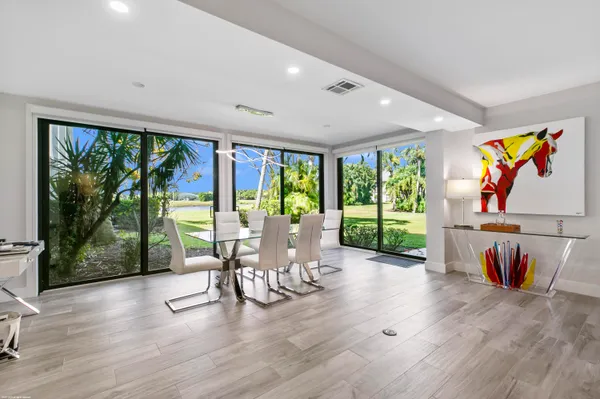 a view of a work space with wooden floor and furniture