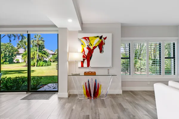 a view of a living room and floor to ceiling window or wooden floor
