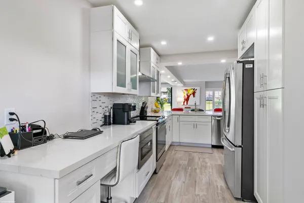 a kitchen with a refrigerator and a sink