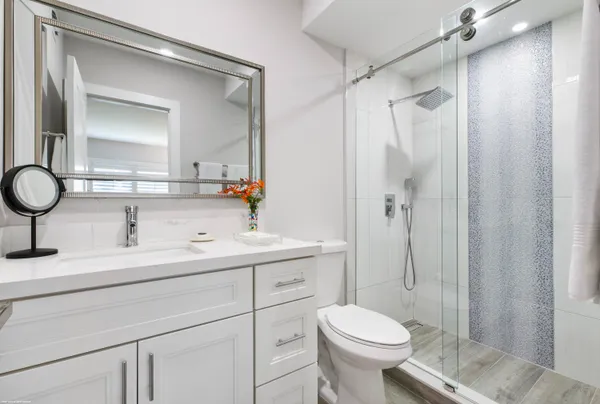 a bathroom with a sink toilet and shower