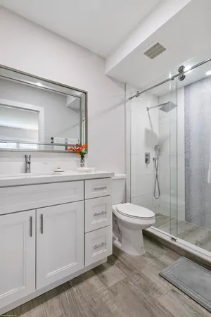 a bathroom with a sink toilet and shower