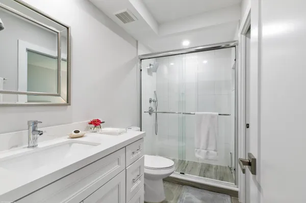 a bathroom with a sink toilet and shower