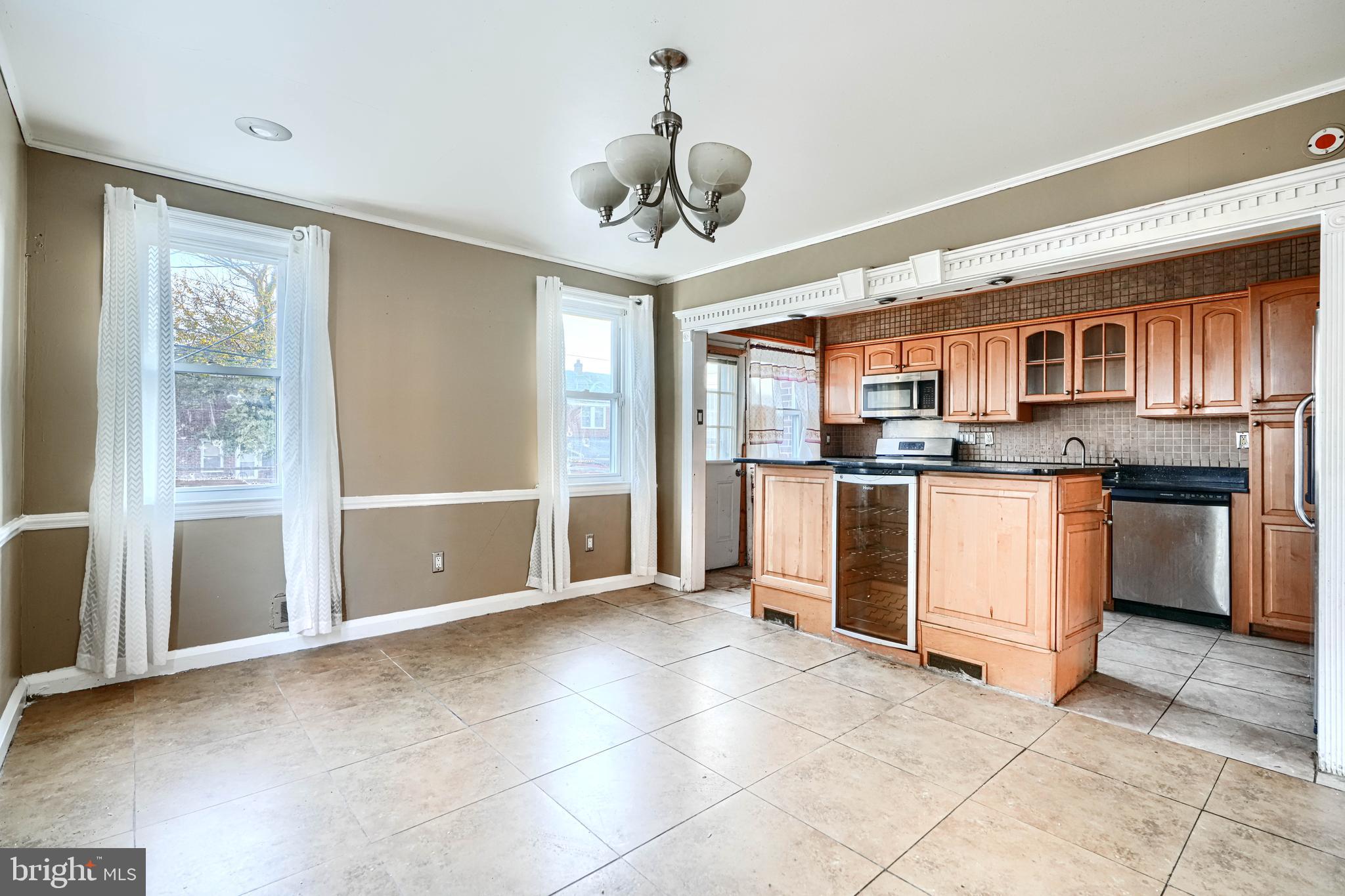 1517 Medford Road Baltimore, MD 21218 - Photo 11 of 27 a view of kitchen with stainless steel appliances granite countertop a stove top oven a refrigerator and a sink