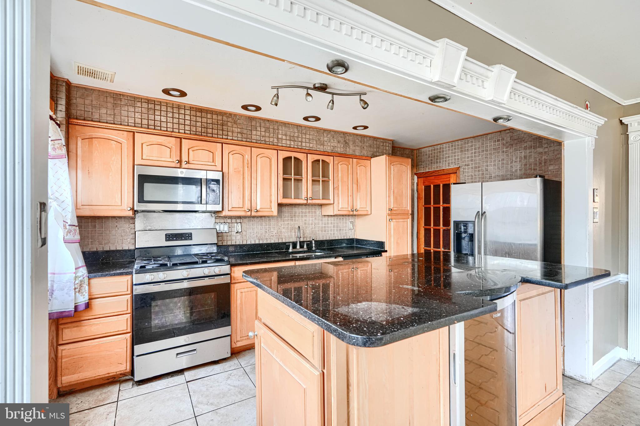 1517 Medford Road Baltimore, MD 21218 - Photo 12 of 27 a kitchen with stainless steel appliances granite countertop a sink a stove and cabinets