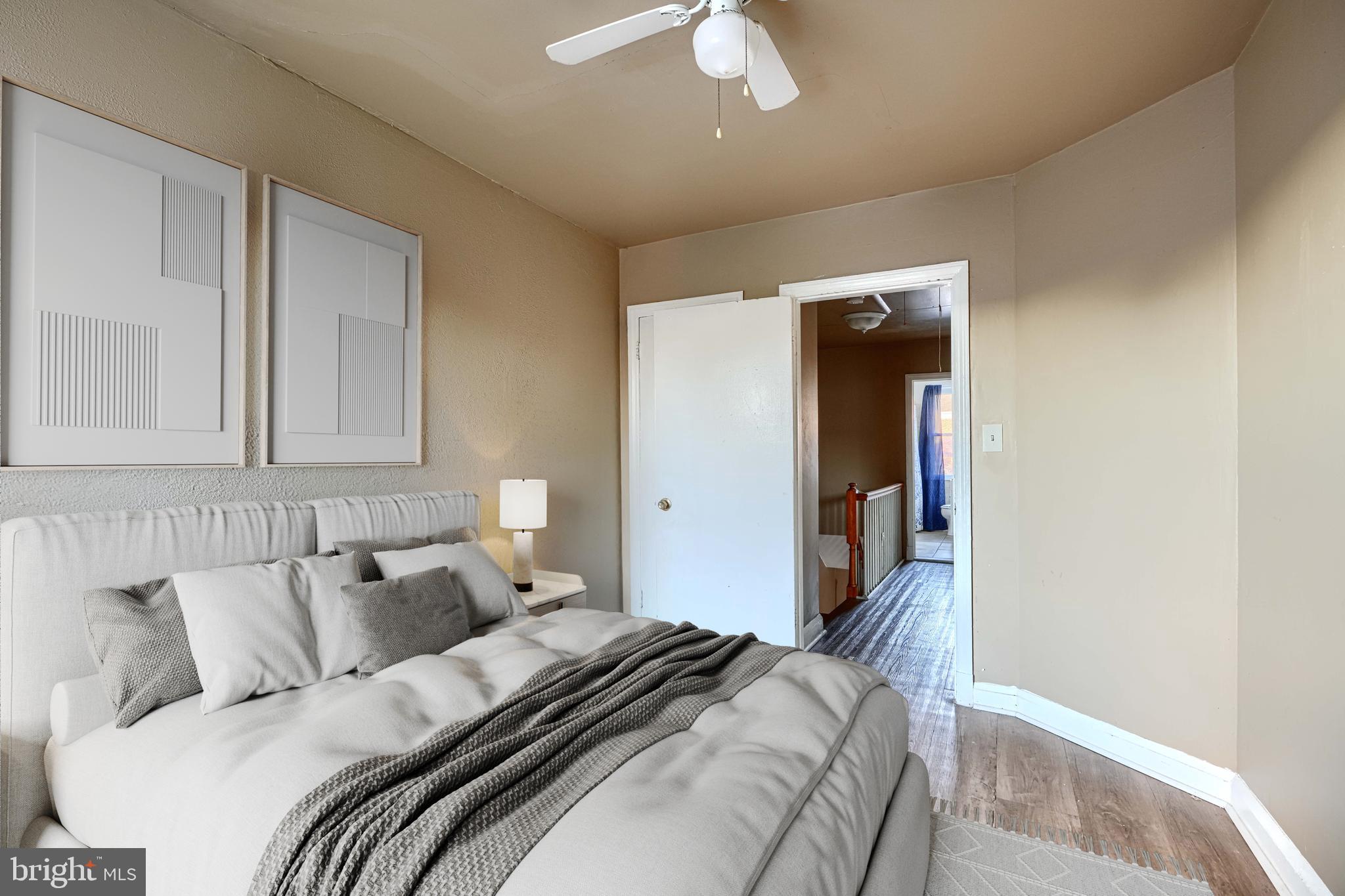 1517 Medford Road Baltimore, MD 21218 - Photo 15 of 27 a bedroom with a bed and a lamp