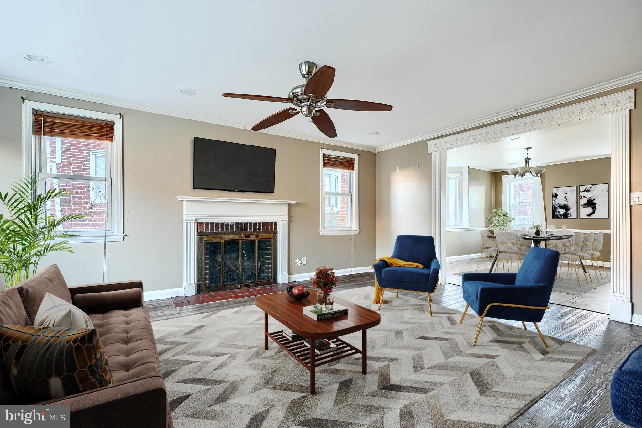 1517 Medford Road Baltimore, MD 21218 - Photo 4 of 27 a living room with furniture a fireplace and a flat screen tv