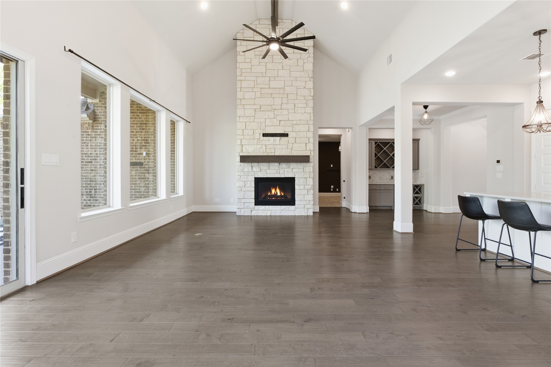 633 Ashbrook Ridge Lane Pinehurst, TX 77362 - Photo 13 of 35 an empty room with fireplace wooden floor and windows