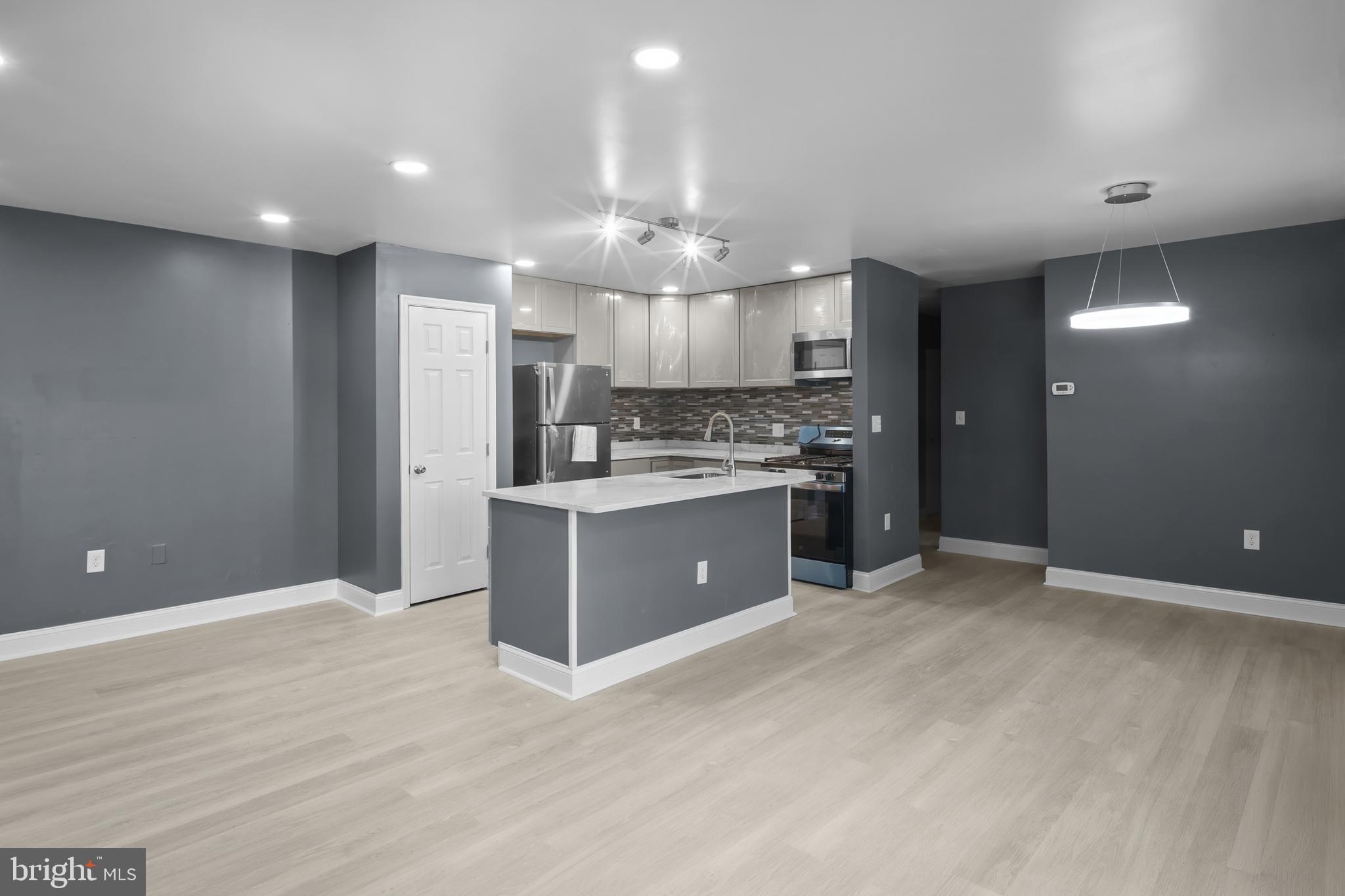 2 Mountbatten Court Baltimore, MD 21207 - Photo 2 of 13 a large kitchen with a large counter space a sink stainless steel appliances and cabinets