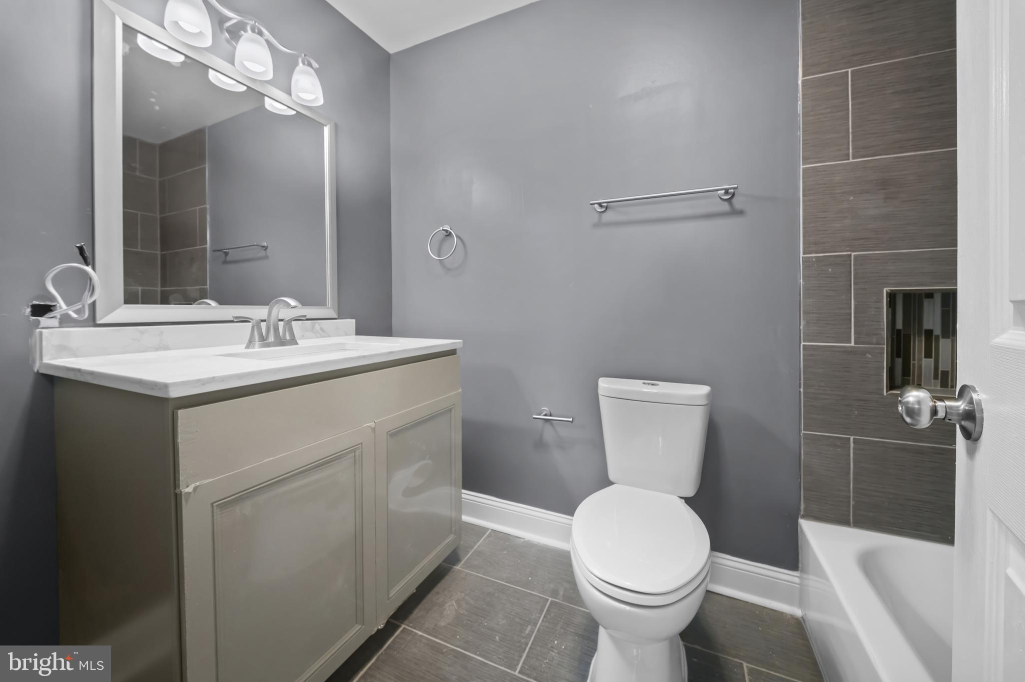 2 Mountbatten Court Baltimore, MD 21207 - Photo 4 of 13 a bathroom with a toilet sink and mirror