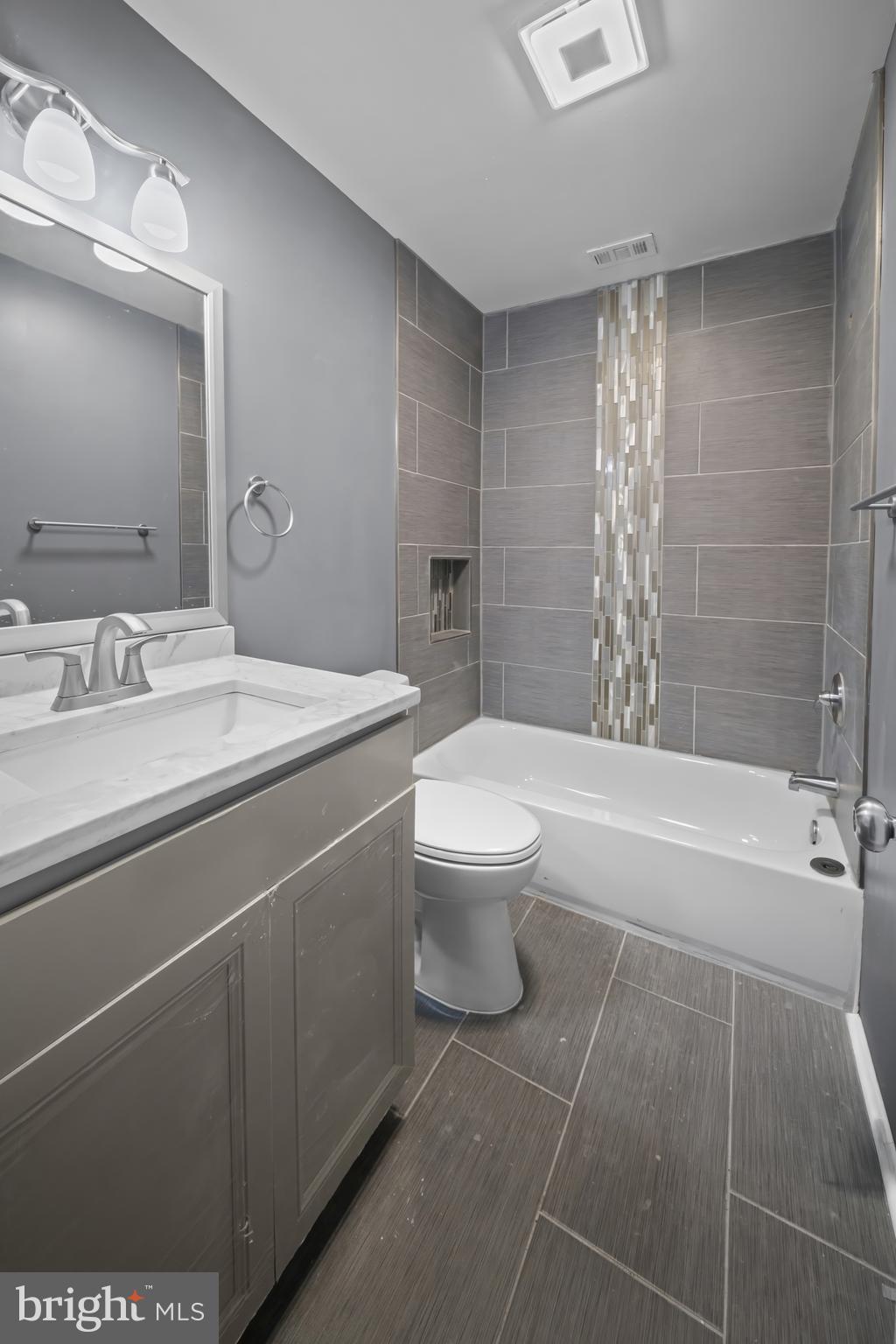 2 Mountbatten Court Baltimore, MD 21207 - Photo 7 of 13 a bathroom with a sink a toilet and shower