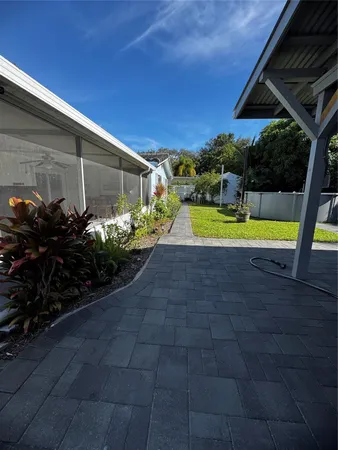 a view of a backyard with plants and a patio