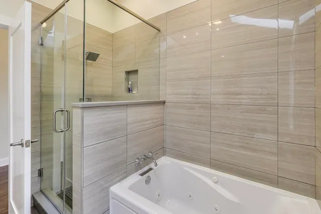 a bathroom with a bathtub and shower