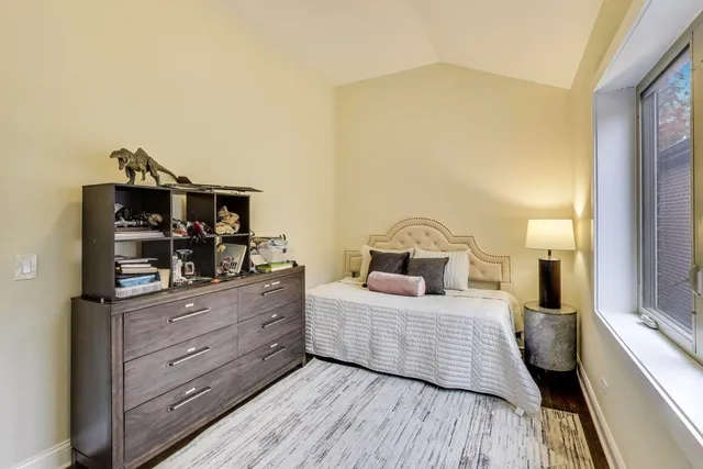 a bedroom with a bed and a large mirror on dresser