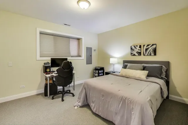 a bedroom with a bed and a table