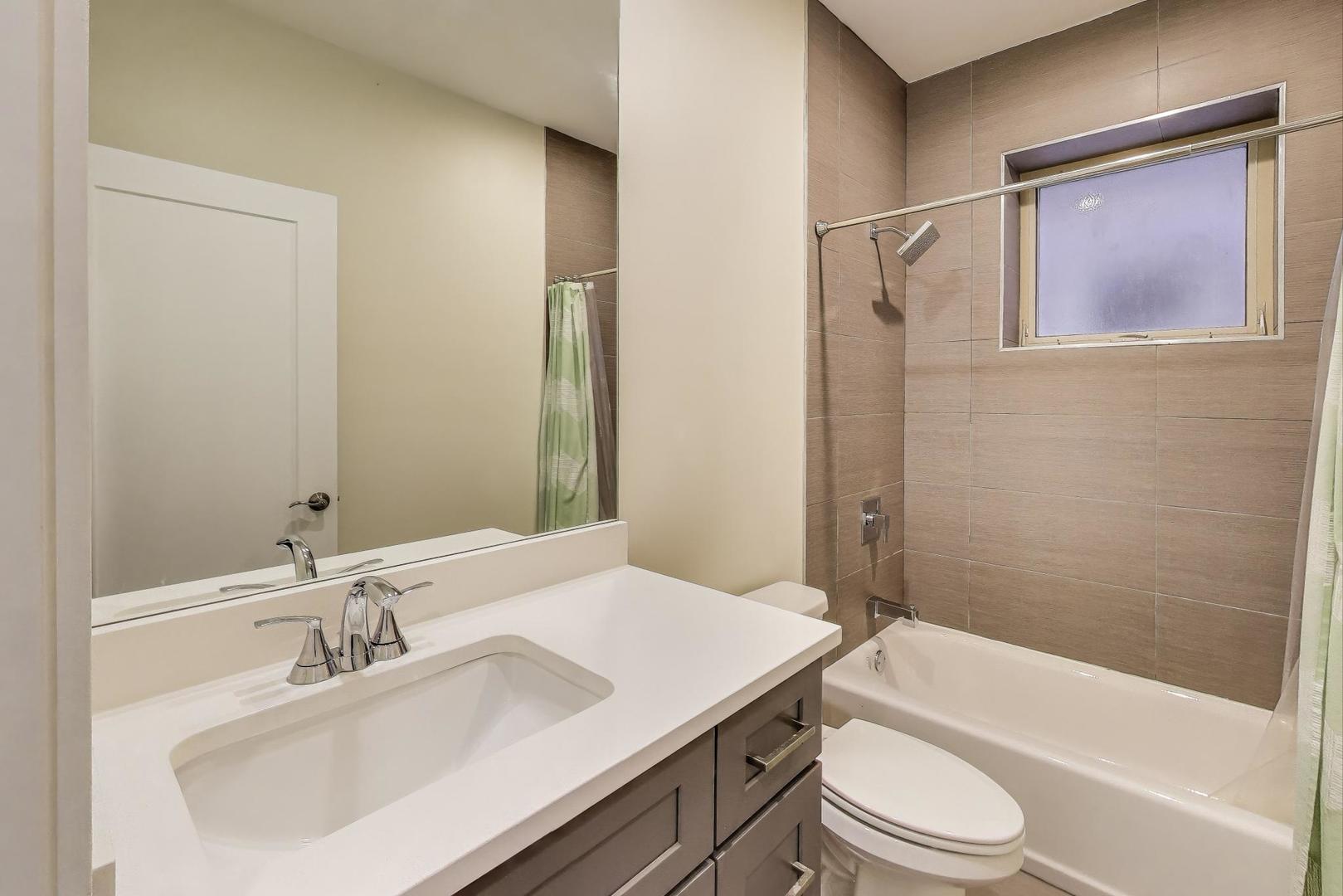 1045 West 34th Place Chicago, IL 60608 - Photo 28 of 35 a bathroom with a sink toilet and shower