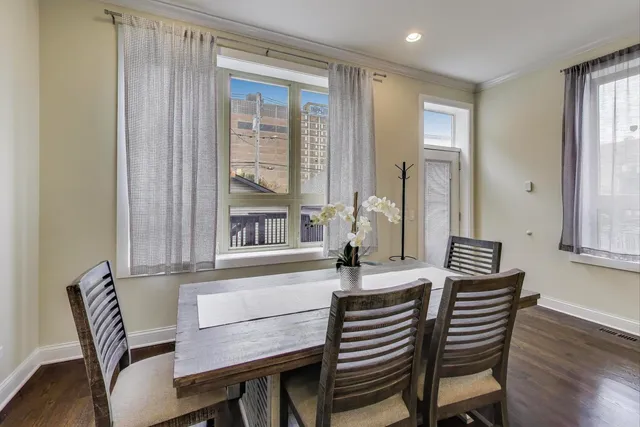 a view of a dining room with furniture and wooden floor