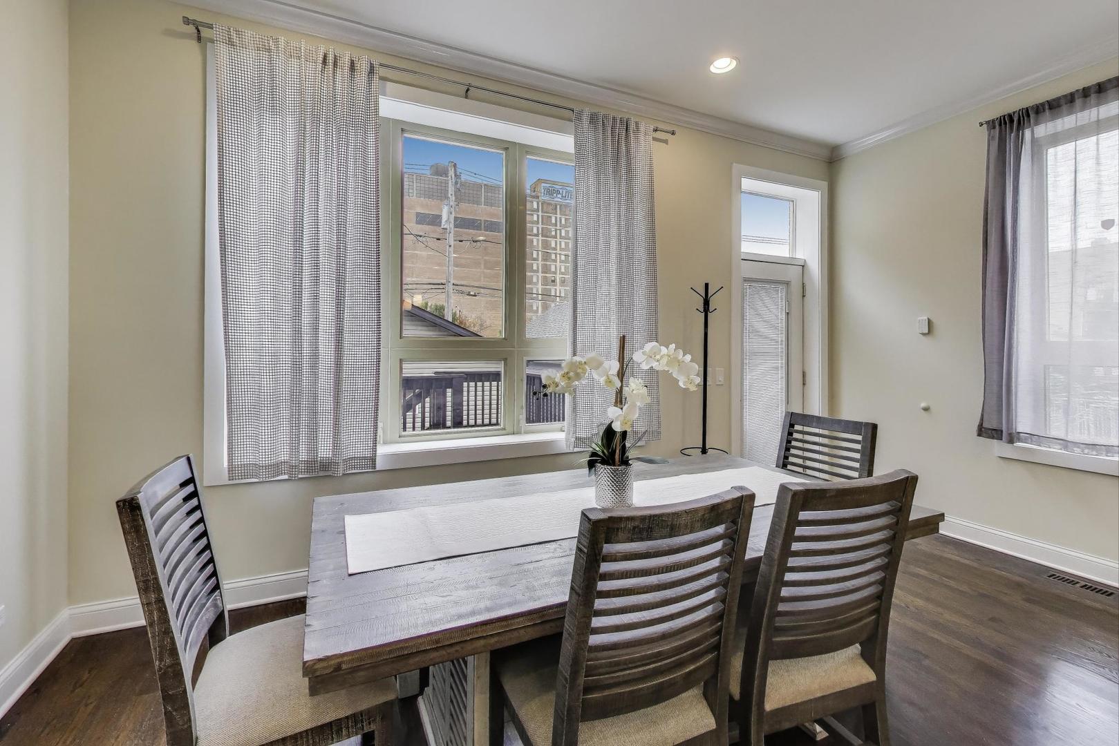 1045 West 34th Place Chicago, IL 60608 - Photo 6 of 35 a view of a dining room with furniture and wooden floor