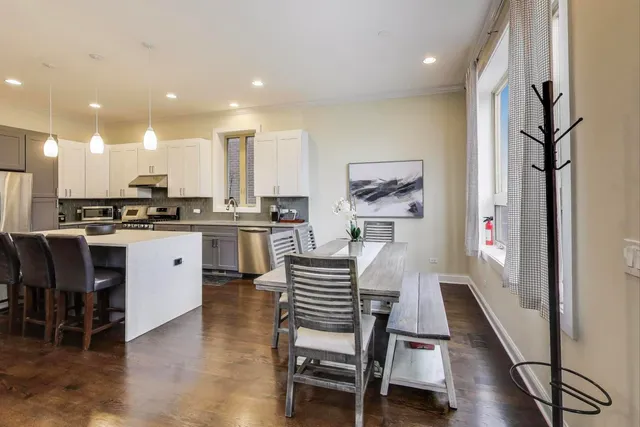 a kitchen with a table and chairs