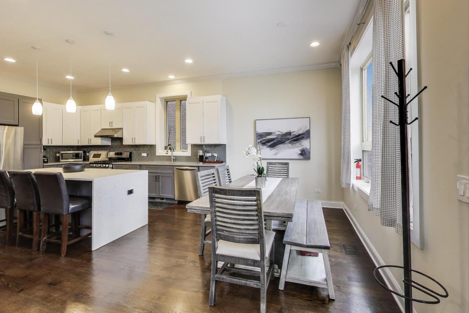1045 West 34th Place Chicago, IL 60608 - Photo 8 of 35 a kitchen with a table and chairs