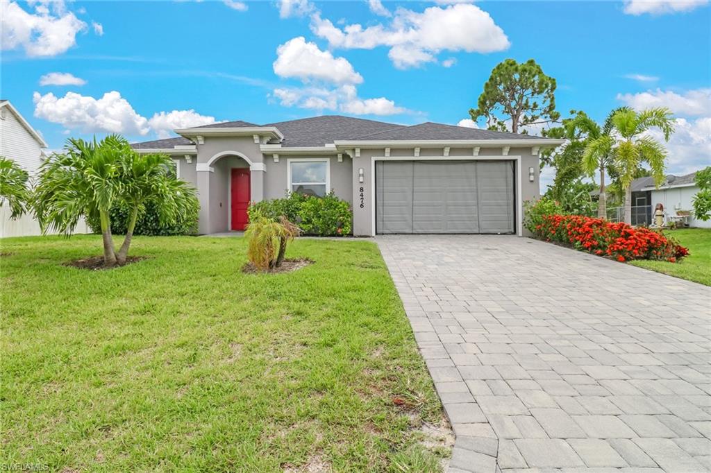 8476 Grove Road Fort Myers, FL 33967 - Photo 1 of 25 a front view of a house with garden