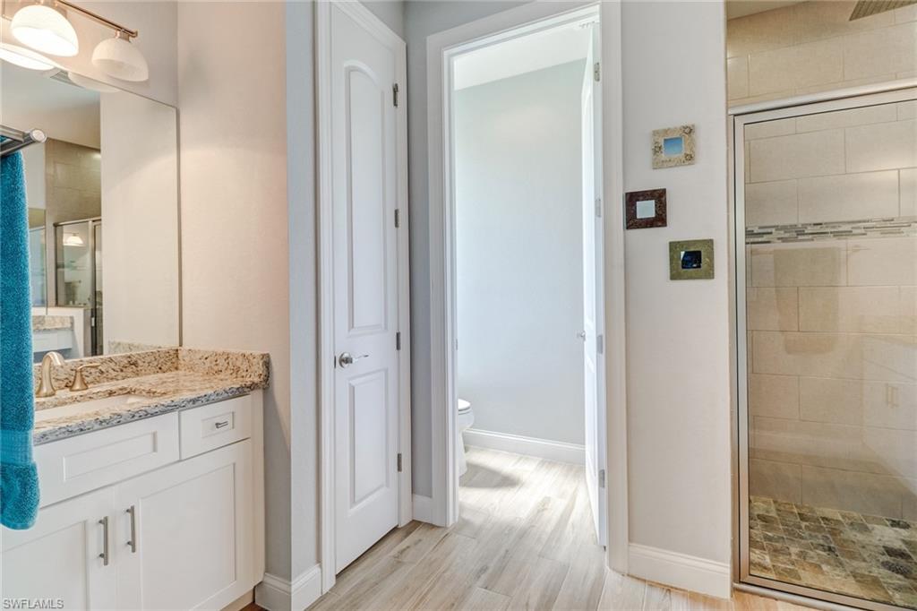 8476 Grove Road Fort Myers, FL 33967 - Photo 16 of 25 a bathroom with a granite countertop sink a shower and a mirror