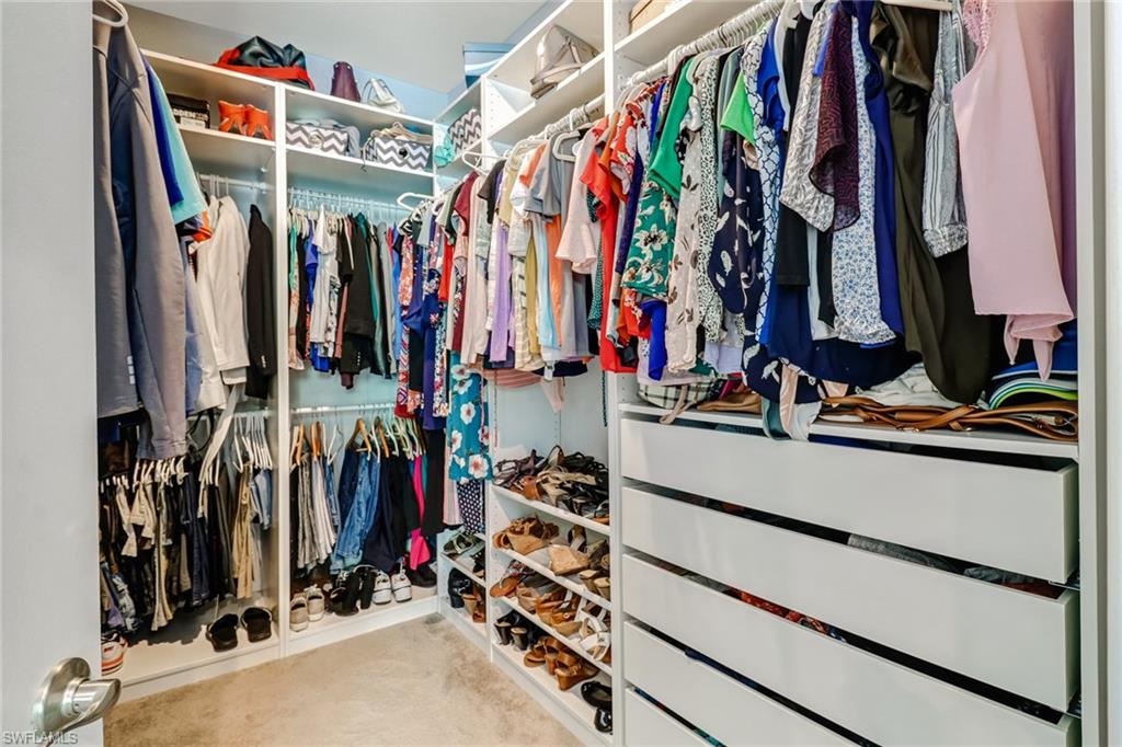 8476 Grove Road Fort Myers, FL 33967 - Photo 17 of 25 a view of walk in closet with clothes