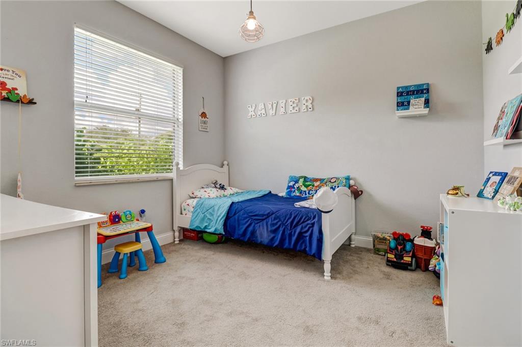 8476 Grove Road Fort Myers, FL 33967 - Photo 19 of 25 a bedroom with a bed and a window