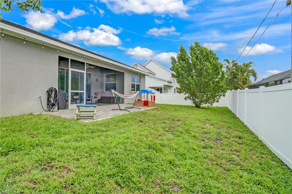8476 Grove Road Fort Myers, FL 33967 - Photo 24 of 25 a front view of a house with garden