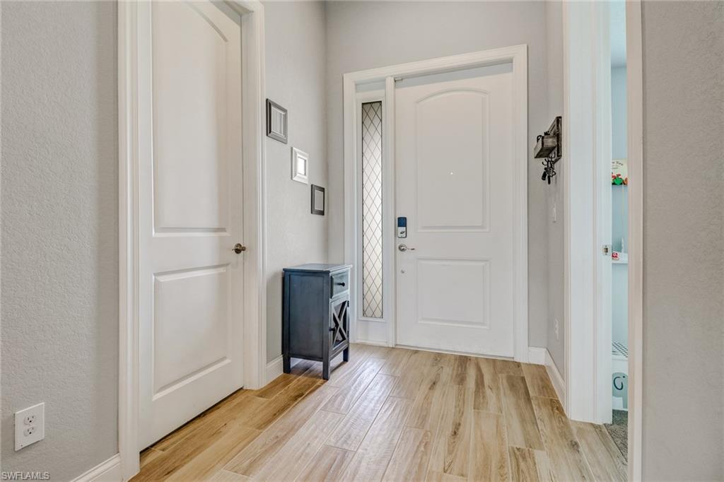 8476 Grove Road Fort Myers, FL 33967 - Photo 3 of 25 a view of a hallway with wooden floor and closet area