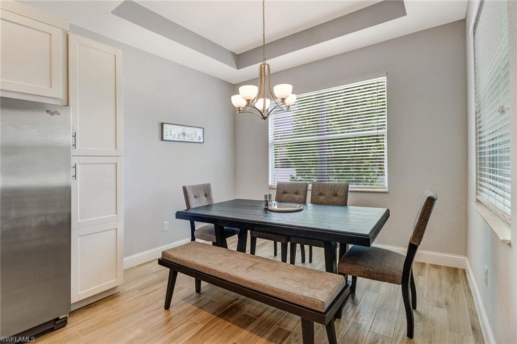 8476 Grove Road Fort Myers, FL 33967 - Photo 7 of 25 a view of a dining room with furniture window and wooden floor